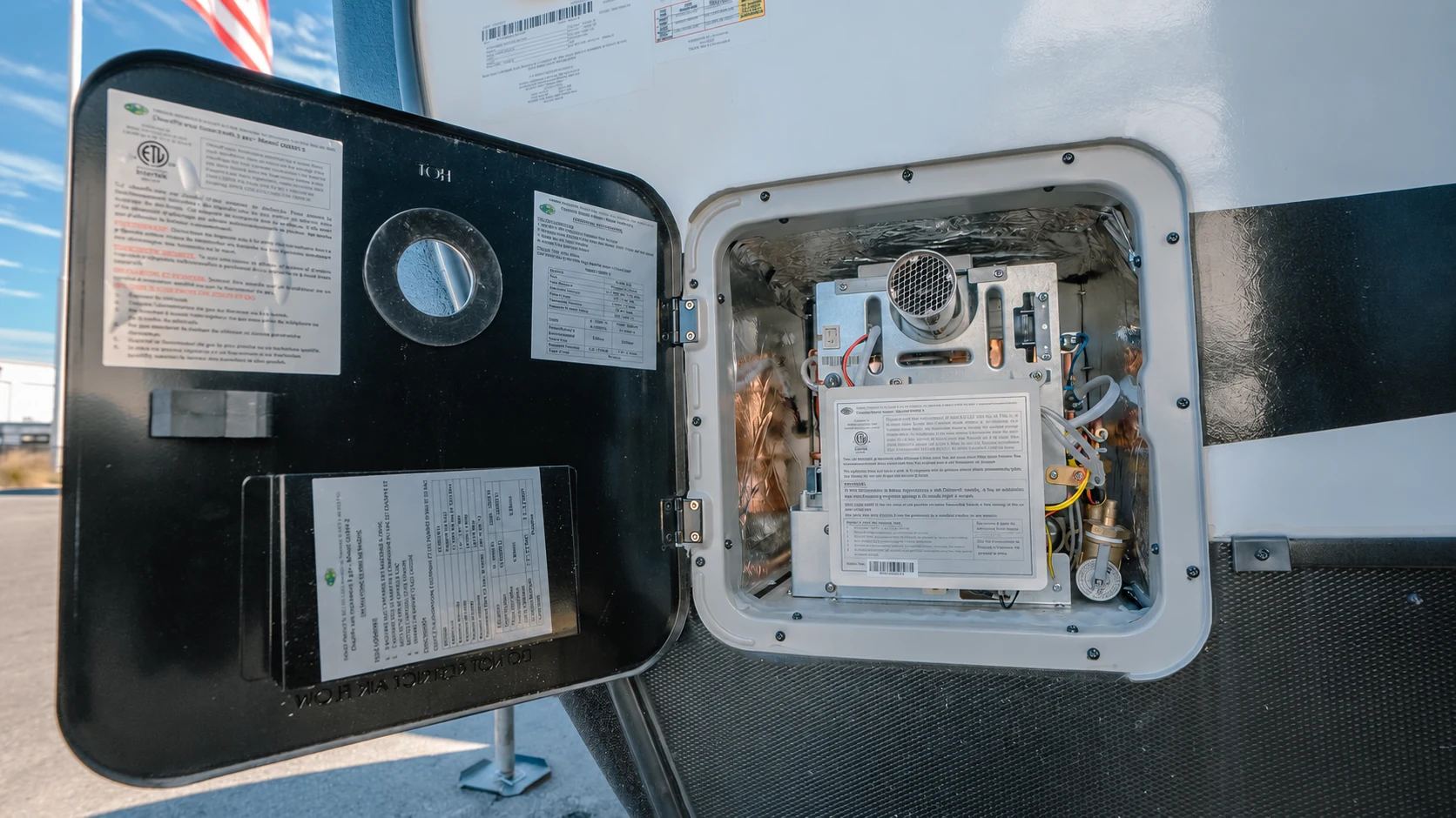 Open exterior RV water-heater compartment